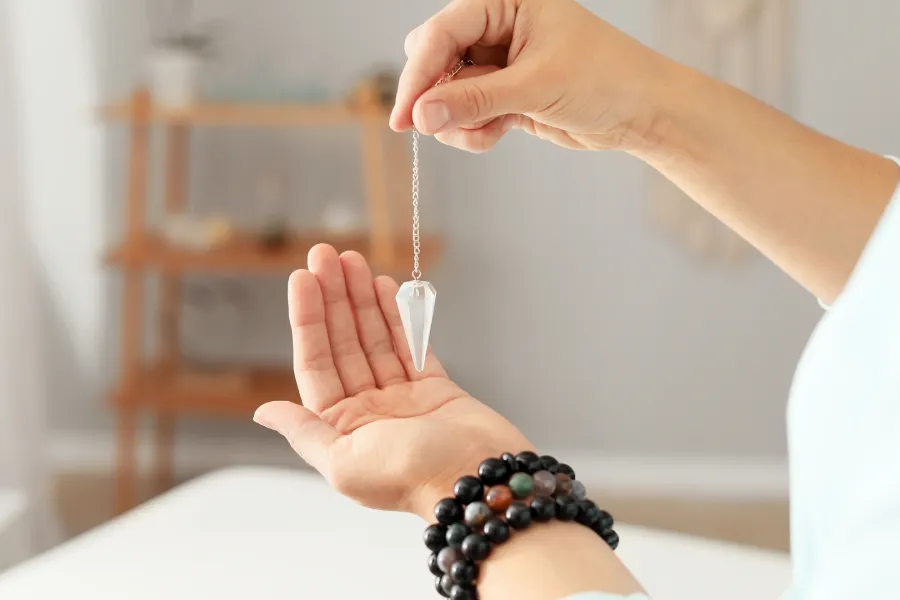Pendule de radiesthésie et pierres énergétiques pour capter les vibrations invisibles