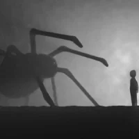 Silhouette d’une araignée sur fond sombre, représentant les peurs profondes et phobies inconscientes